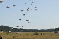 Several parachutes descend to the ground. Photo by Sgt. Juan F. Jiminez
